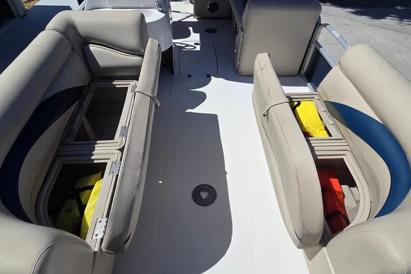 Slide: The Image of 2014 Hurricane FunDeck 216 OB boat interior with open storage compartments and seating. - 6