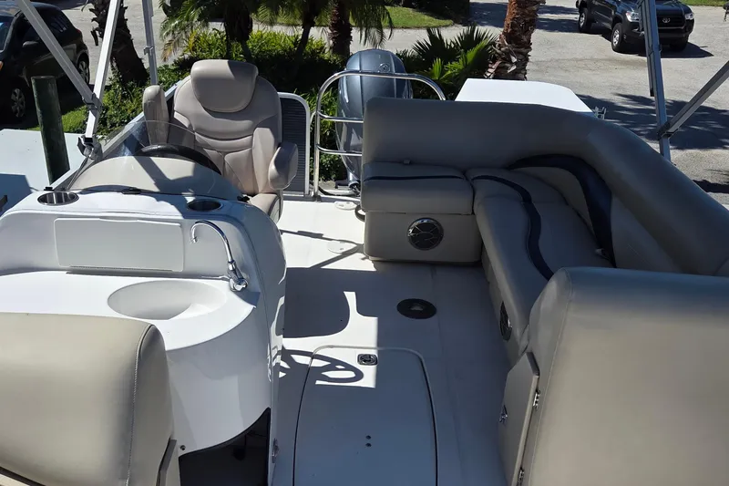 Slide: The Image of 2014 Hurricane FunDeck 216 OB interior with seating, steering console, and sink. - 7