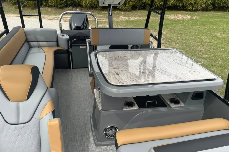 Slide: The Image of Interior of 2025 Tahoe 2785 boat with modern seating and table design. - 10