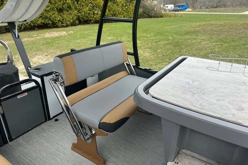 Slide: The Image of 2025 Tahoe 2785 boat interior with gray and tan seating, and a marble-patterned table. - 14