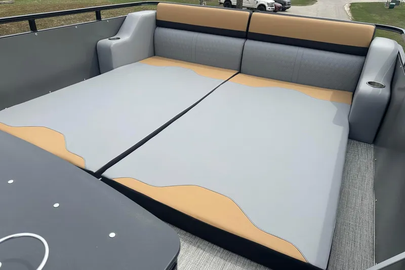 Slide: The Image of 2025 Tahoe 2785 boat interior with spacious, cushioned seating in gray and tan. - 19