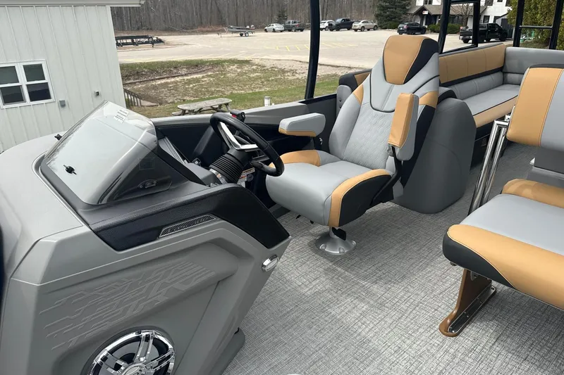 Slide: The Image of Interior of 2025 Tahoe 2785 boat with modern seating and steering console. - 24