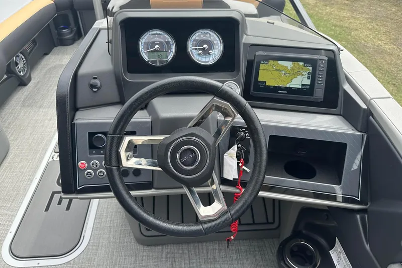 Slide: The Image of Steering console of 2025 Tahoe 2785 boat with navigation display and gauges. - 25