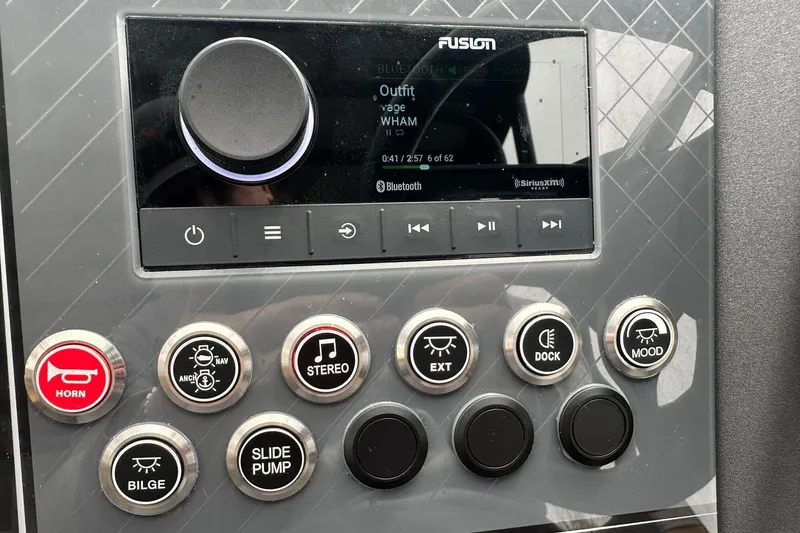 Slide: The Image of Control panel of a 2025 Tahoe 2785 boat with stereo and function buttons. - 26