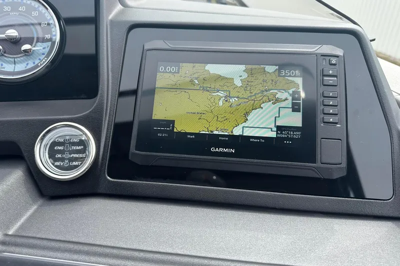 Slide: The Image of Dashboard of 2025 Tahoe 2785 with Garmin navigation system and engine indicators. - 27