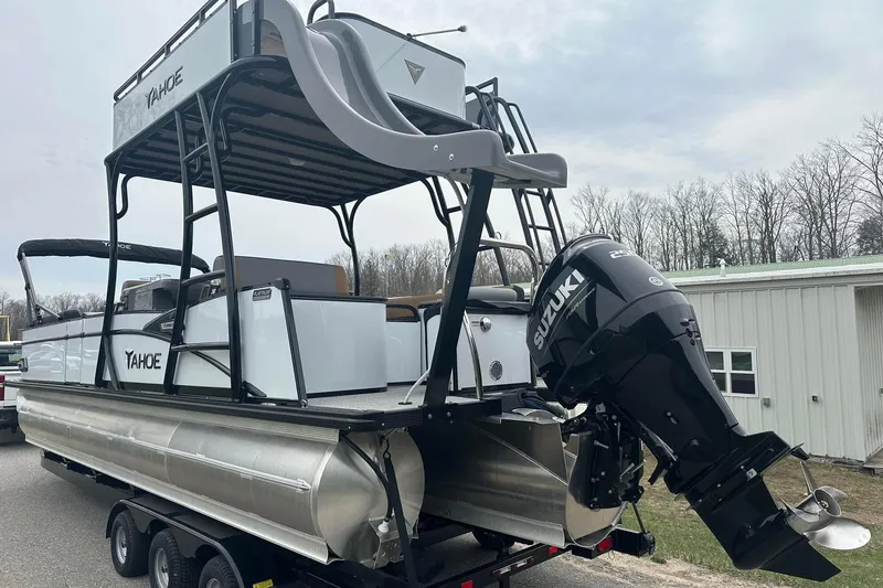 Slide: The Image of 2025 Tahoe 2785 pontoon boat with Suzuki outboard motor on trailer. - 3