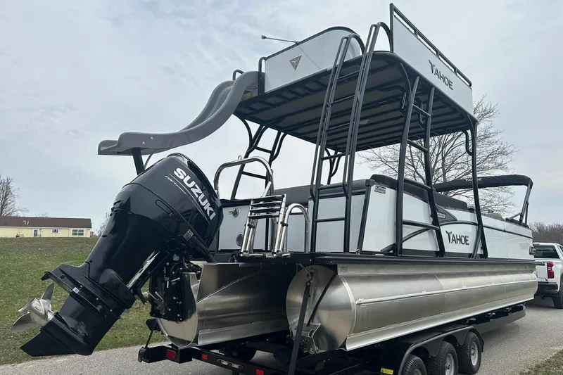 Slide: The Image of 2025 Tahoe 2785 pontoon boat with slide and Suzuki outboard motor on trailer. - 6