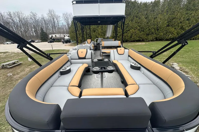 Slide: The Image of 2025 Tahoe 2785 boat with spacious seating and modern design on a grassy area. - 9