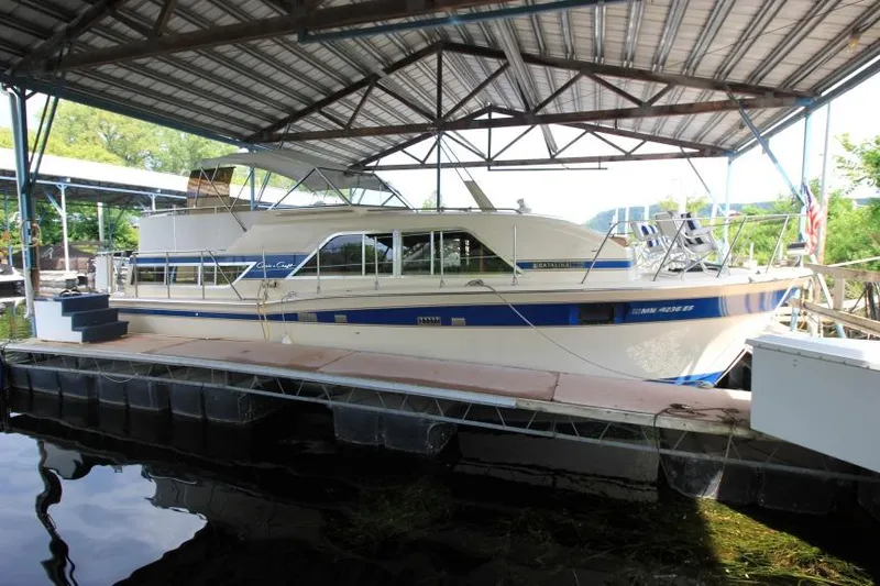 Slide: The Image of 1983 Chris-Craft 350 Catalina yacht docked under a metal canopy. - 1