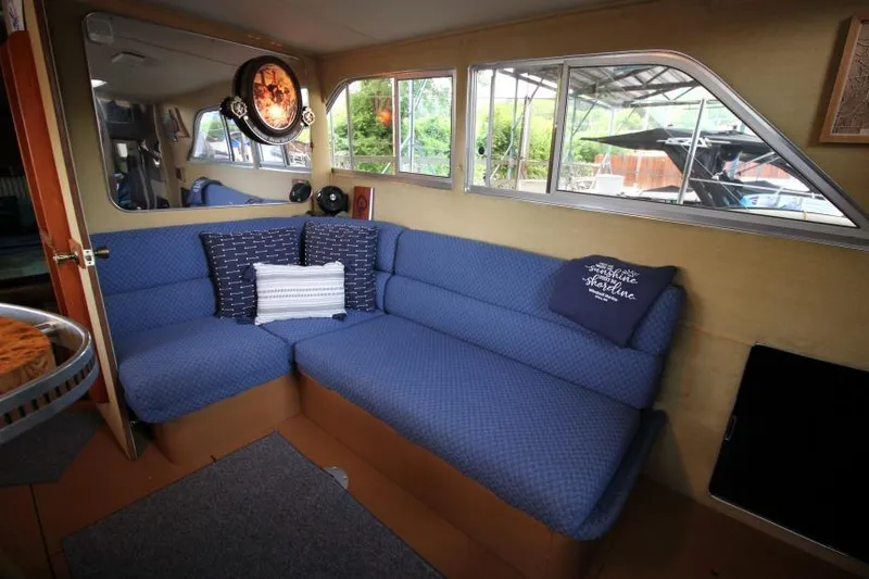 Slide: The Image of Interior of 1983 Chris-Craft 350 Catalina with blue seating and decorative pillows. - 10