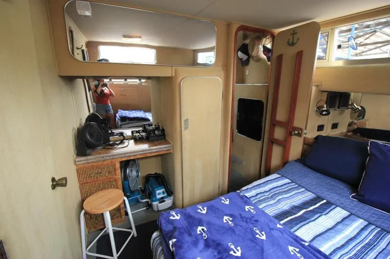 Slide: The Image of Interior of 1983 Chris-Craft 350 Catalina with nautical decor and cozy sleeping area. - 17