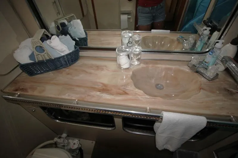 Slide: The Image of 1983 Chris-Craft 350 Catalina bathroom with marble countertop, sink, and toiletries. - 19