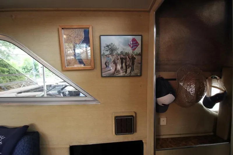 Slide: The Image of Interior of 1983 Chris-Craft 350 Catalina with framed art and hats on wall. - 22