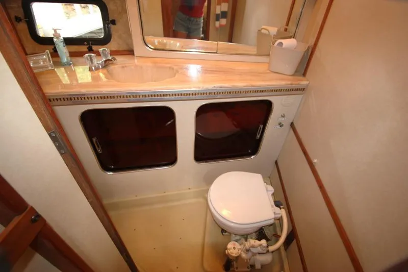 Slide: The Image of 1983 Chris-Craft 350 Catalina bathroom with sink, mirror, and toilet. - 23
