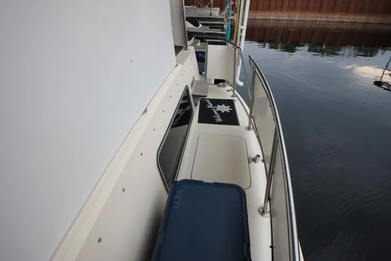 Slide: The Image of 1983 Chris-Craft 350 Catalina boat docked, showing deck and railing details. - 25