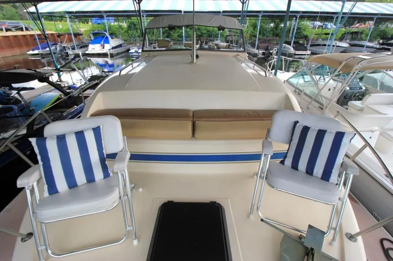 Slide: The Image of 1983 Chris-Craft 350 Catalina yacht with striped cushions and chairs on deck. - 27