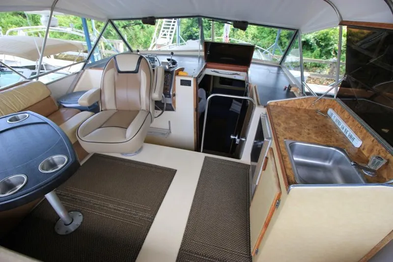 Slide: The Image of Interior of 1983 Chris-Craft 350 Catalina boat with seating, table, and kitchenette. - 3