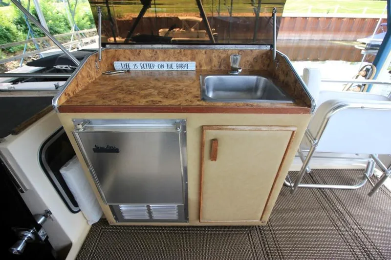 Slide: The Image of 1983 Chris-Craft 350 Catalina boat kitchenette with sink and mini fridge. - 4