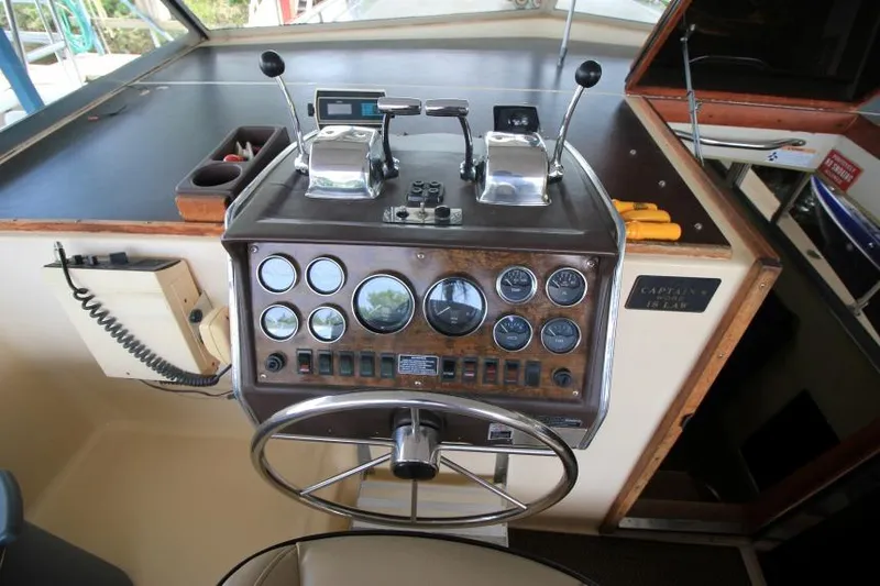 Slide: The Image of 1983 Chris-Craft 350 Catalina helm with gauges, controls, and steering wheel. - 7