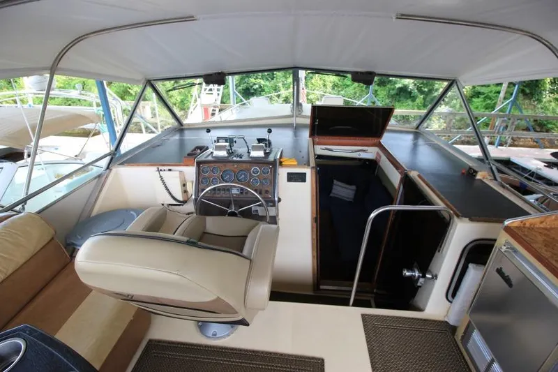 Slide: The Image of 1983 Chris-Craft 350 Catalina boat interior with helm, seating, and cabin entrance. - 8