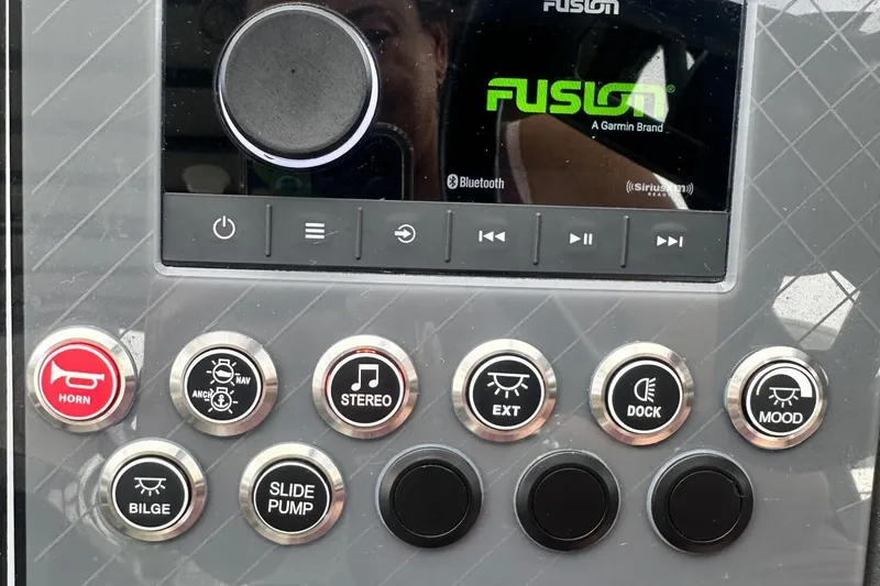 Slide: The Image of Control panel of a 2025 Tahoe 2785 boat with various function buttons. - 13