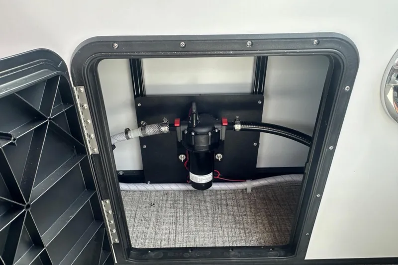 Slide: The Image of 2025 Tahoe 2785 RV compartment with plumbing and wiring components. - 16