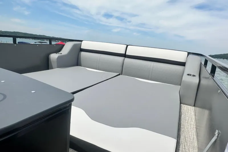 Slide: The Image of 2025 Tahoe 2785 boat interior with gray seating and open water view. - 19