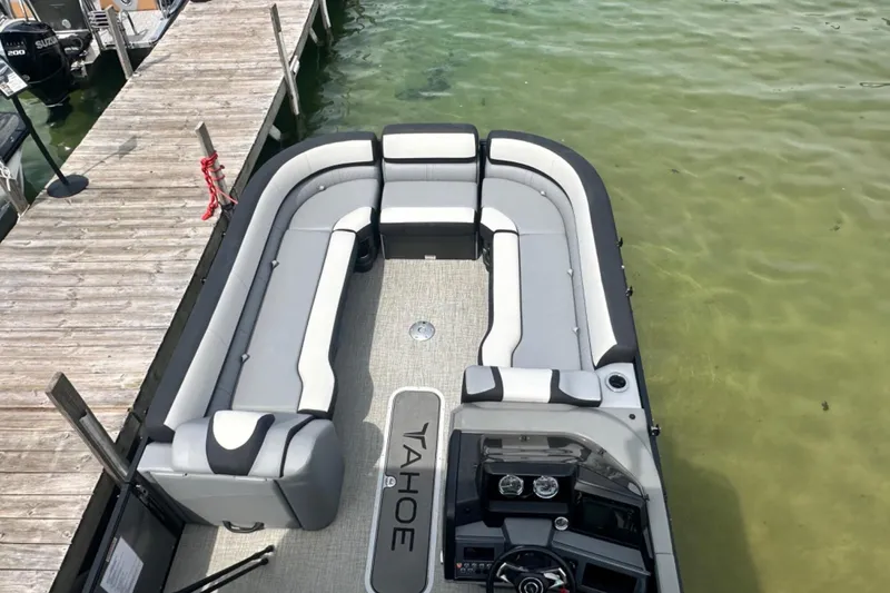 Slide: The Image of 2025 Tahoe 2785 pontoon boat with spacious seating, docked on clear water. - 22