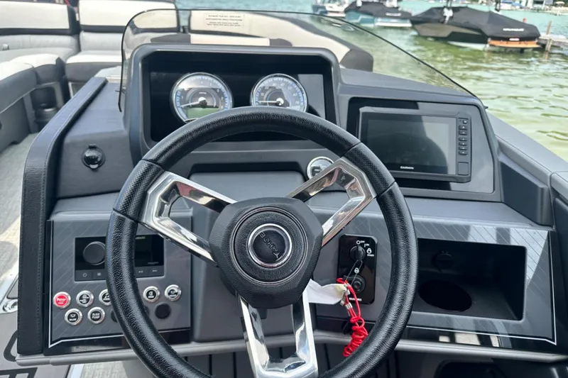 Slide: The Image of Steering wheel and dashboard of 2025 Tahoe 2785 boat, featuring modern controls and gauges. - 7