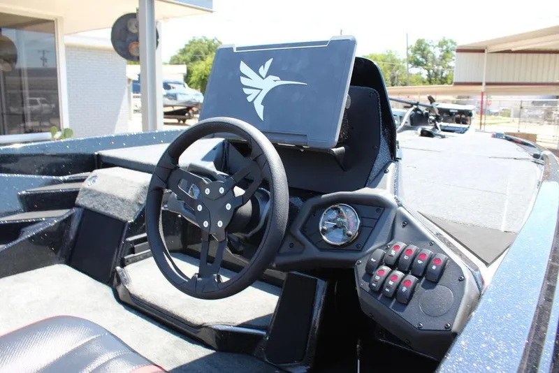 Slide: The Image of 2026 Skeeter ZXE21 boat dashboard with steering wheel and control panel. - 14