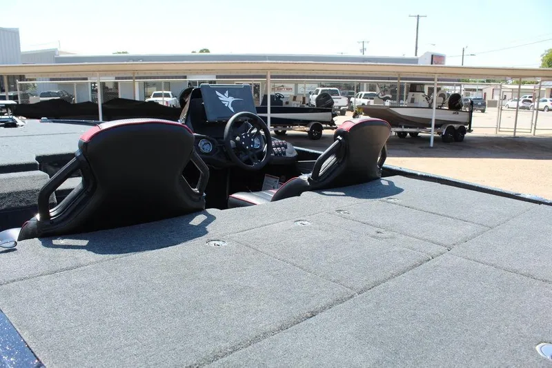 Slide: The Image of 2026 Skeeter ZXE21 boat interior with dual seats and steering console. - 16