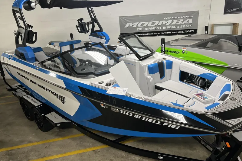 Slide: The Image of 2019 Nautique Super Air Nautique G23 boat in showroom, blue and white design. - 1