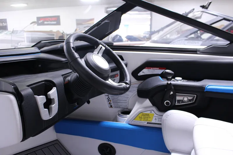 Slide: The Image of 2019 Nautique Super Air Nautique G23 interior with steering wheel and control panel. - 4