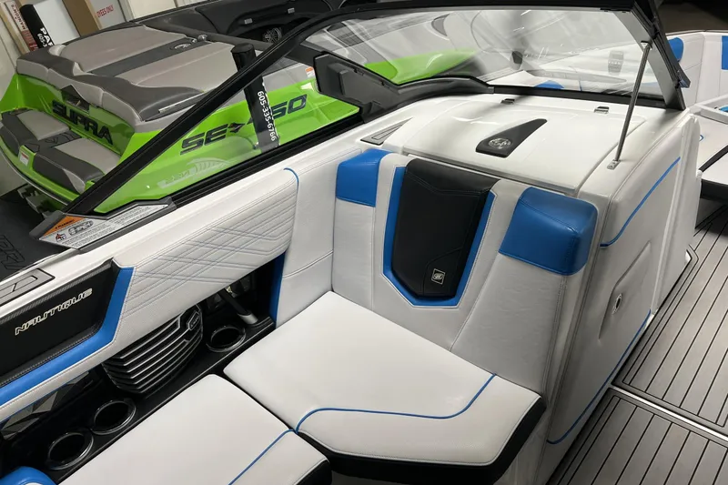 Slide: The Image of 2019 Nautique Super Air Nautique G23 interior with blue and white seating, sleek design. - 7