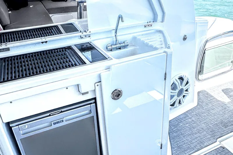 Slide: The Image of Outdoor kitchenette on a 2016 Jeanneau Leader 36 yacht with grill, sink, and mini fridge. - 10