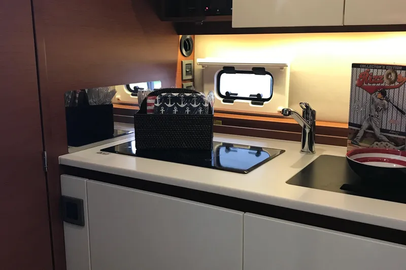 Slide: The Image of 2016 Jeanneau Leader 36 yacht kitchen with modern sink and stove setup. - 14