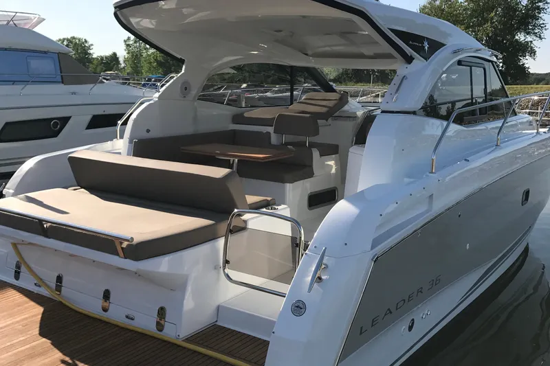 Slide: The Image of 2016 Jeanneau Leader 36 yacht with spacious deck and seating area, docked at marina. - 17