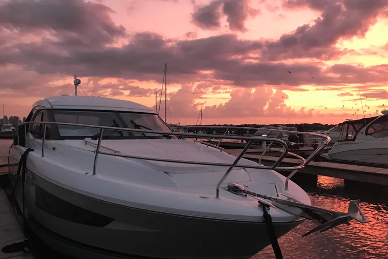 Slide: The Image of Jeanneau Leader 36 yacht docked at sunset, 2016 model, serene marina view. - 23
