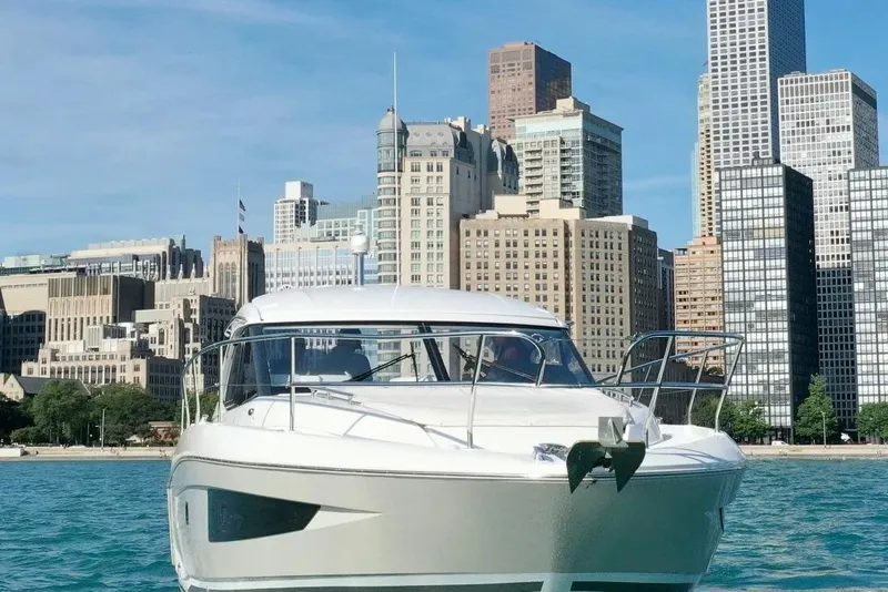 Slide: The Image of 2016 Jeanneau Leader 36 yacht on water with city skyline backdrop. - 3