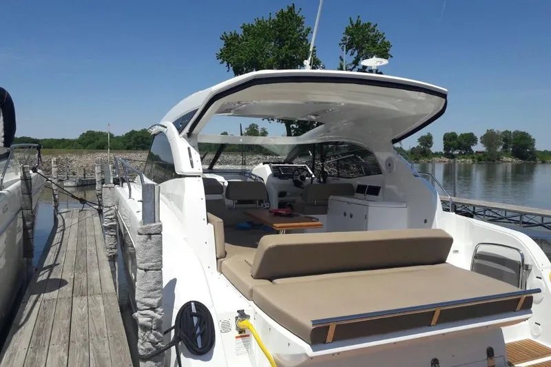 Slide: The Image of 2016 Jeanneau Leader 36 yacht docked, showcasing spacious deck and modern design. - 7