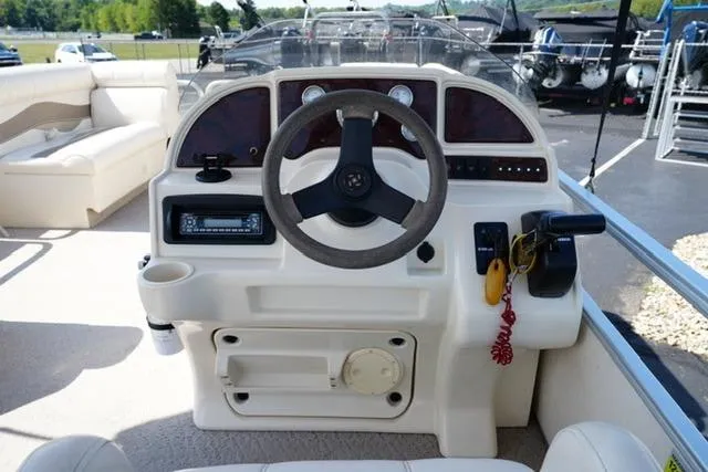 Slide: The Image of 2007 Godfrey 200 Sweetwater boat dashboard with steering wheel and controls. - 10
