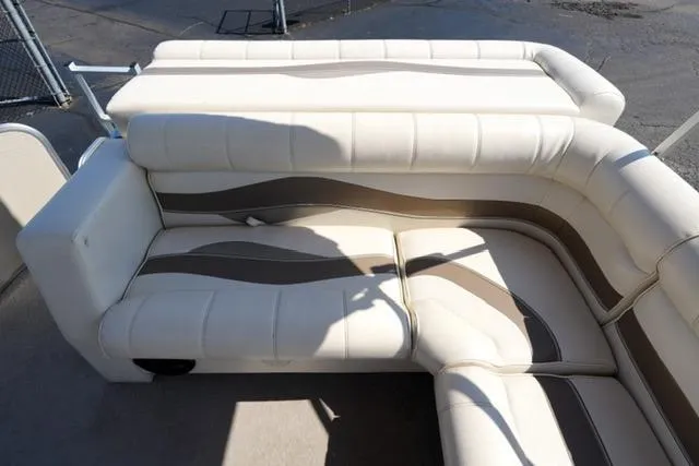 Slide: The Image of 2007 Godfrey 200 Sweetwater boat interior with beige and brown cushioned seating. - 13