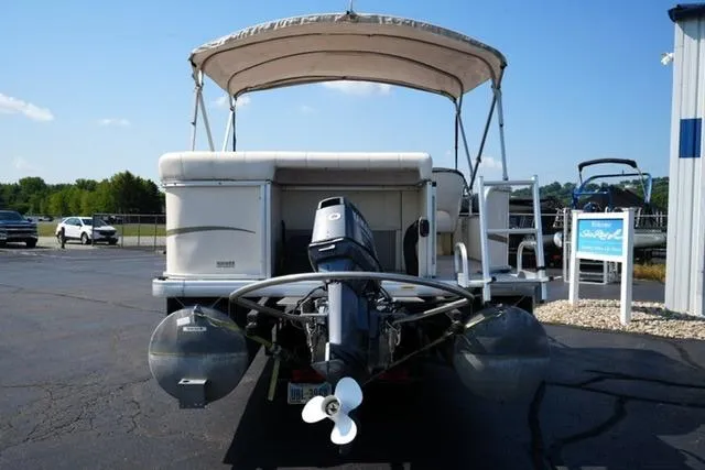 Slide: The Image of 2007 Godfrey 200 Sweetwater pontoon boat with canopy, parked on asphalt. - 6