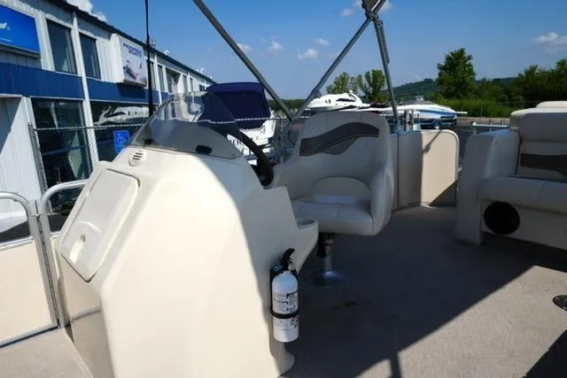 Slide: The Image of 2007 Godfrey 200 Sweetwater boat interior with steering console and seating. - 9