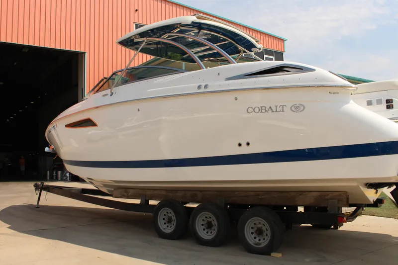 Slide: The Image of 2018 Cobalt R35 boat on trailer outside a large building. - 12