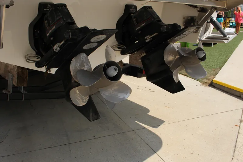 Slide: The Image of Dual propellers on a 2018 Cobalt R35 boat, parked on concrete. - 15