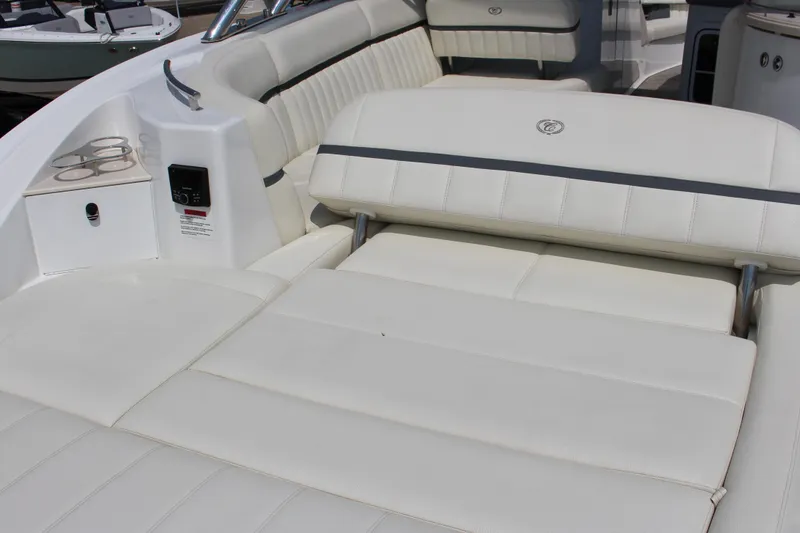 Slide: The Image of Luxurious seating on 2018 Cobalt R35 boat with white upholstery and cup holders. - 18