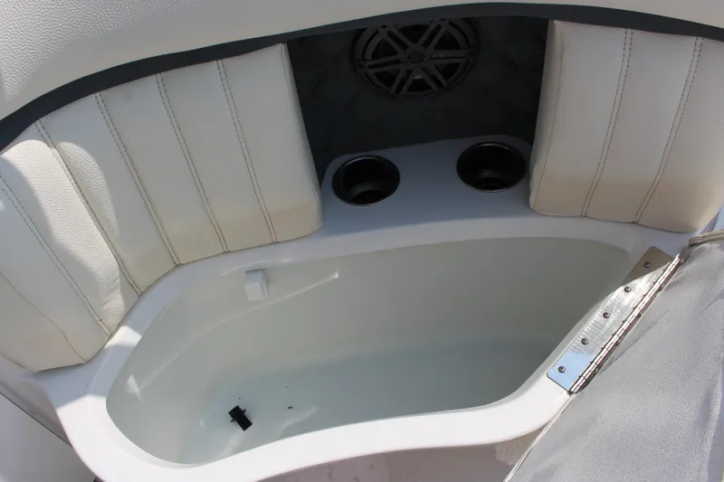 Slide: The Image of 2018 Cobalt R35 boat interior with white seating, cup holders, and speaker. - 23