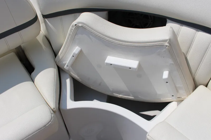 Slide: The Image of 2018 Cobalt R35 boat with open storage compartment under white cushioned seating. - 24