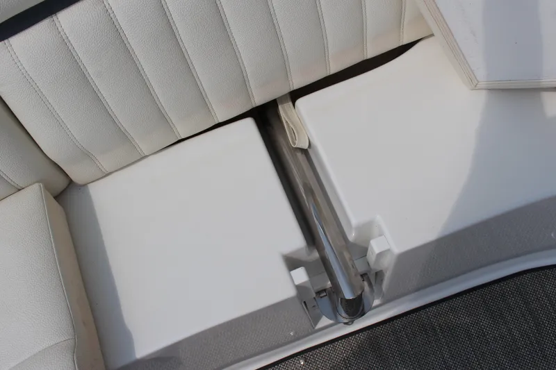 Slide: The Image of 2018 Cobalt R35 boat interior with white cushioned seating and metal handrail. - 25